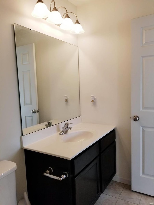 bathroom with tile patterned floors, vanity, and toilet