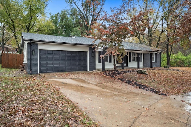 ranch-style home featuring a garage and covered porch