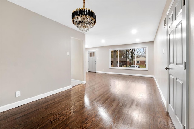 interior space featuring dark wood-type flooring and an inviting chandelier