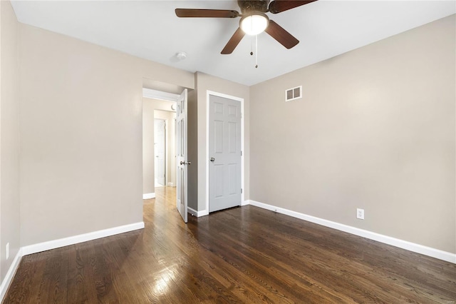 unfurnished bedroom featuring ceiling fan and dark hardwood / wood-style flooring