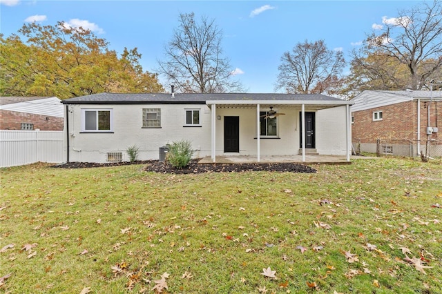 back of property with a patio, ceiling fan, and a lawn