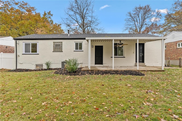 rear view of house with a lawn, ceiling fan, and a patio