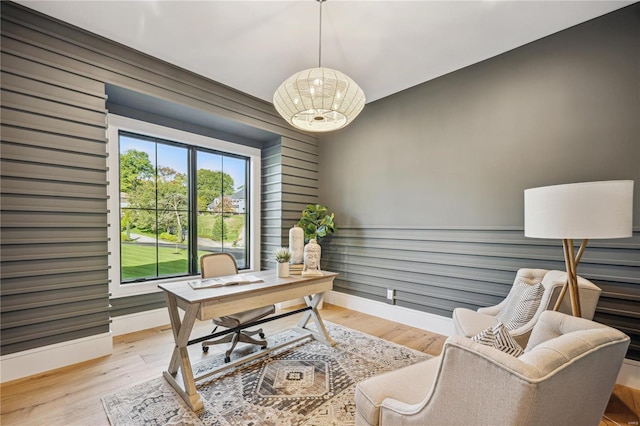 office featuring light hardwood / wood-style flooring and a chandelier