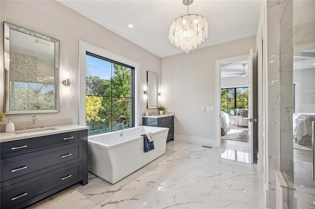 bathroom featuring vanity, a chandelier, and separate shower and tub