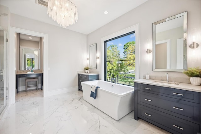 bathroom featuring vanity, a tub to relax in, and a notable chandelier