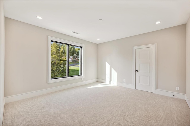 unfurnished room with light colored carpet