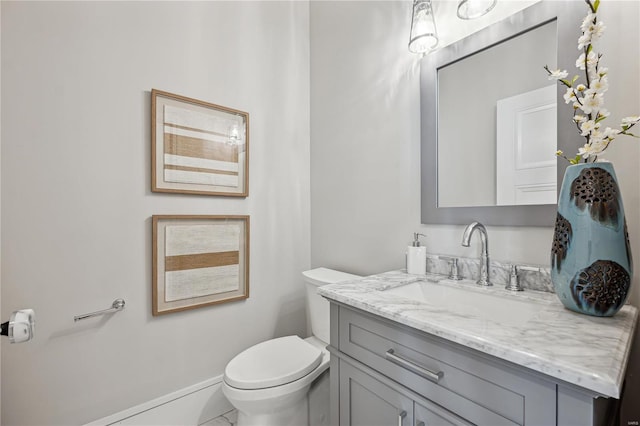 bathroom featuring vanity, toilet, and tile patterned floors