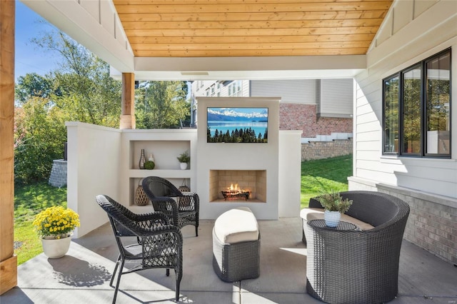 view of patio with exterior fireplace