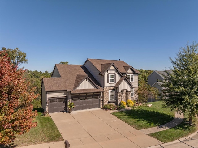 view of front of property featuring a front yard and a garage