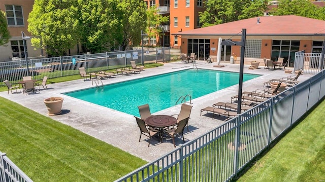 view of pool with a yard and a patio