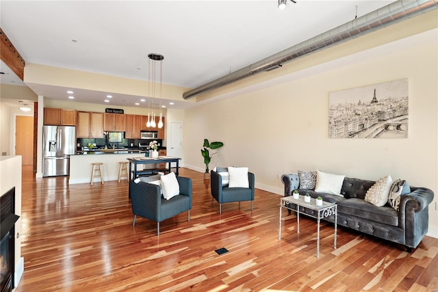 living room with light hardwood / wood-style flooring