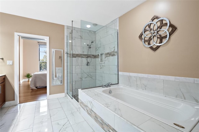 bathroom featuring vanity and independent shower and bath