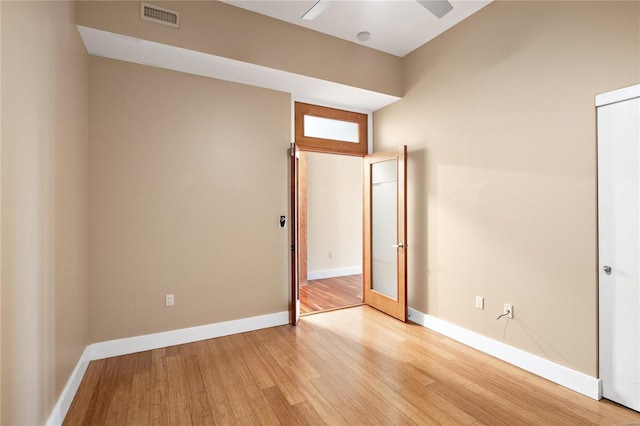 empty room with light hardwood / wood-style flooring