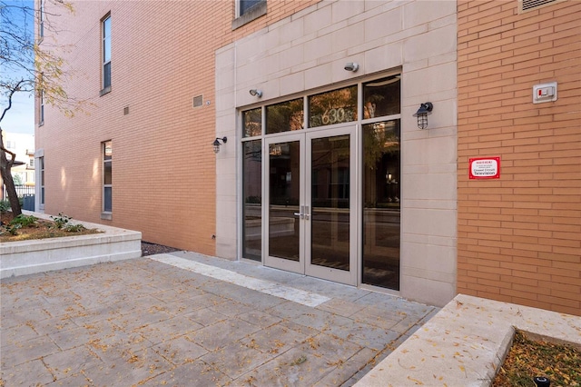 view of exterior entry featuring a patio