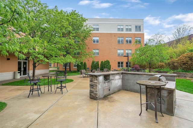 view of patio featuring exterior kitchen and an outdoor bar