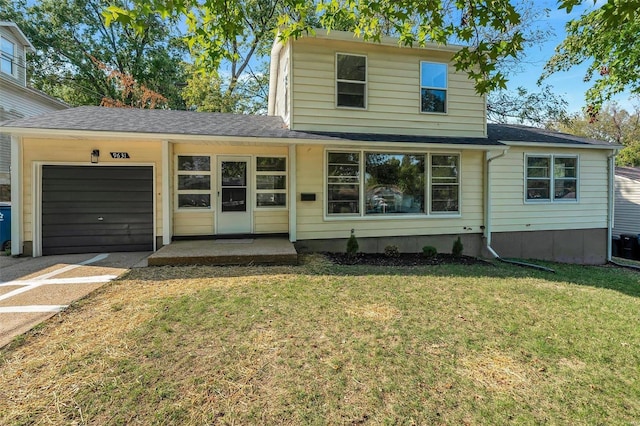 view of front property featuring a garage and a front lawn