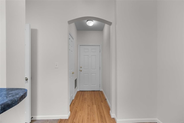 corridor with hardwood / wood-style floors