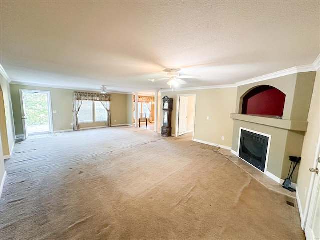 unfurnished living room with crown molding, light colored carpet, a textured ceiling, and ceiling fan