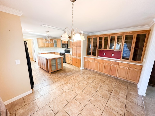 kitchen with ornamental molding, a kitchen island, decorative light fixtures, black appliances, and a notable chandelier