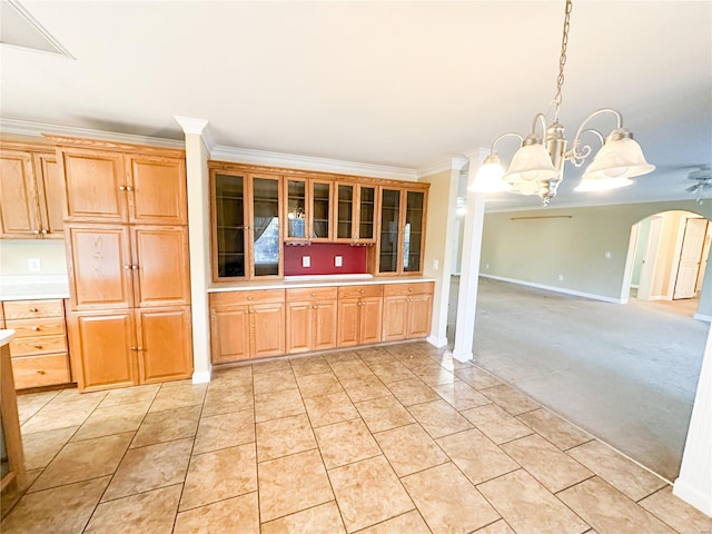 kitchen featuring ceiling fan with notable chandelier, crown molding, decorative light fixtures, and light tile patterned floors