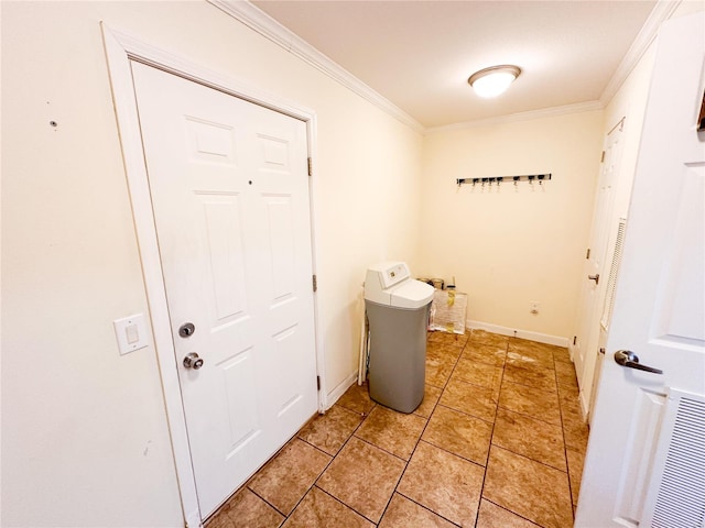 entryway featuring light tile patterned flooring and ornamental molding