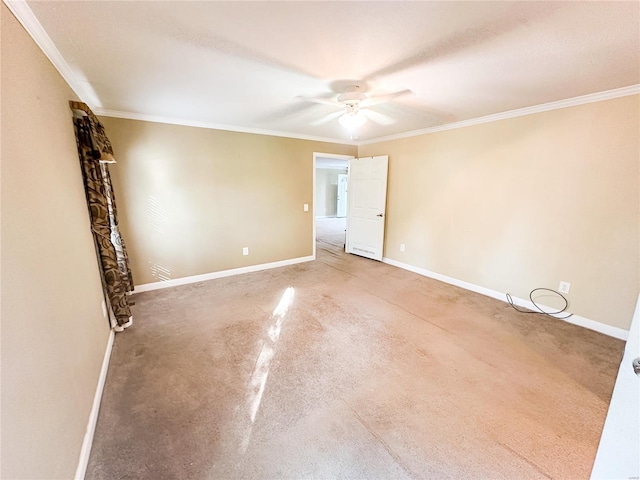 empty room with crown molding, ceiling fan, and carpet flooring