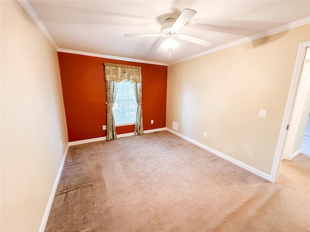 carpeted spare room with crown molding and ceiling fan