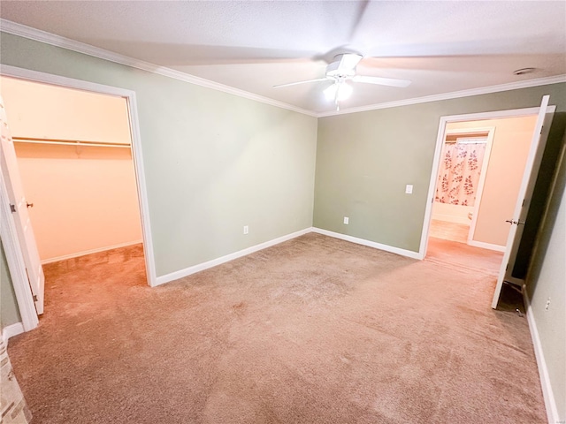 unfurnished bedroom featuring ceiling fan, light carpet, and a spacious closet