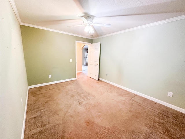 carpeted empty room featuring ornamental molding, a textured ceiling, and ceiling fan