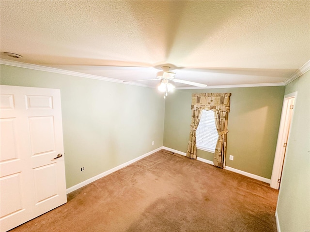 carpeted spare room with ceiling fan, ornamental molding, and a textured ceiling