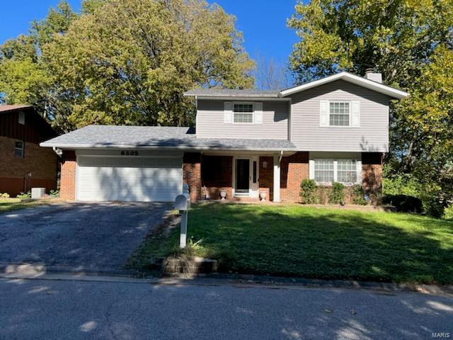 front facade with a front lawn and a garage