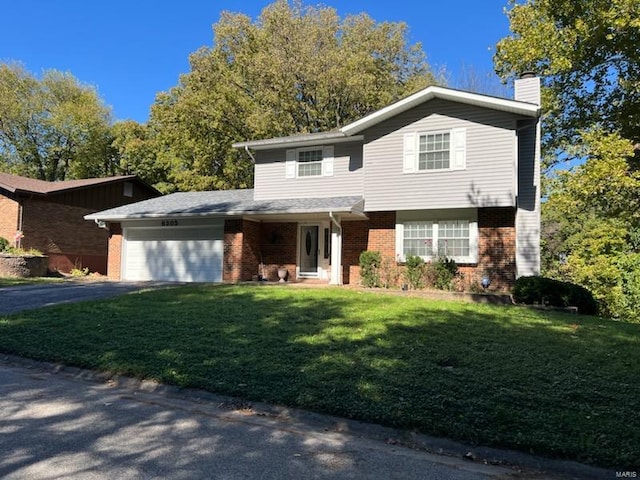 view of property featuring a front lawn and a garage