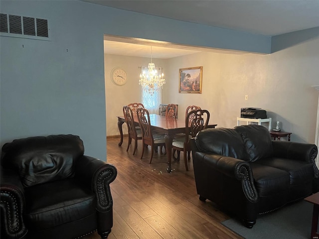 living room featuring a notable chandelier and hardwood / wood-style flooring