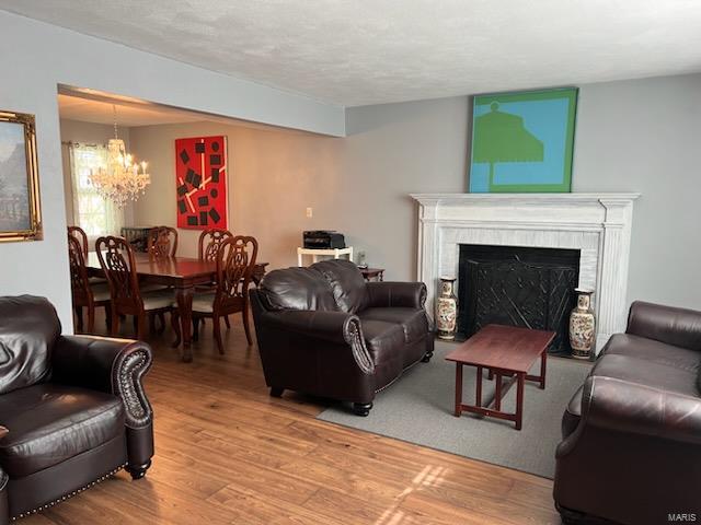 living room with a notable chandelier and hardwood / wood-style flooring