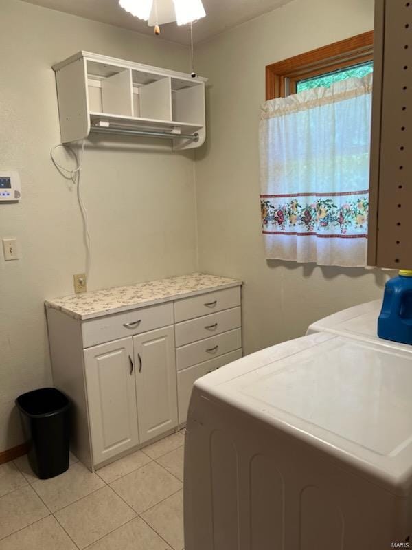 laundry area with washer and dryer, cabinets, light tile patterned floors, and ceiling fan