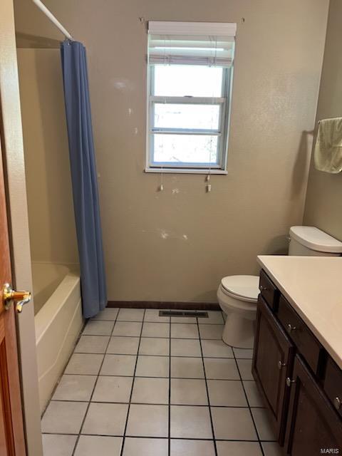 full bathroom with vanity, shower / bath combo, toilet, and tile patterned flooring