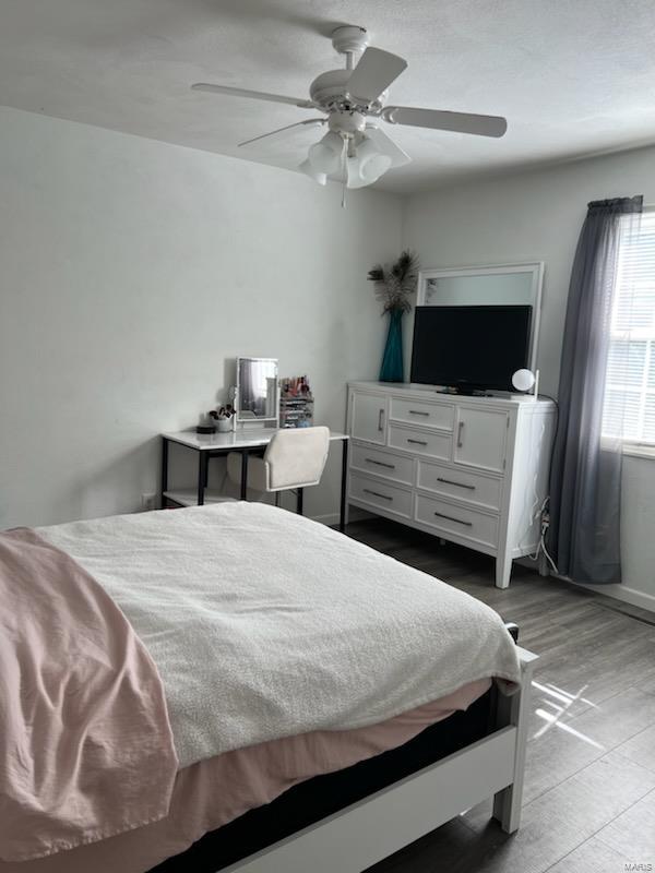 bedroom featuring ceiling fan and light wood-type flooring