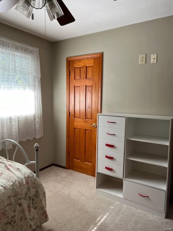 carpeted bedroom with ceiling fan