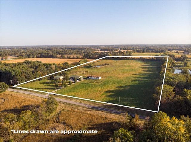 birds eye view of property with a rural view