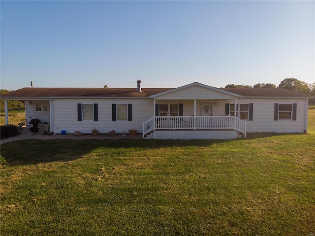 ranch-style home with a front lawn and covered porch