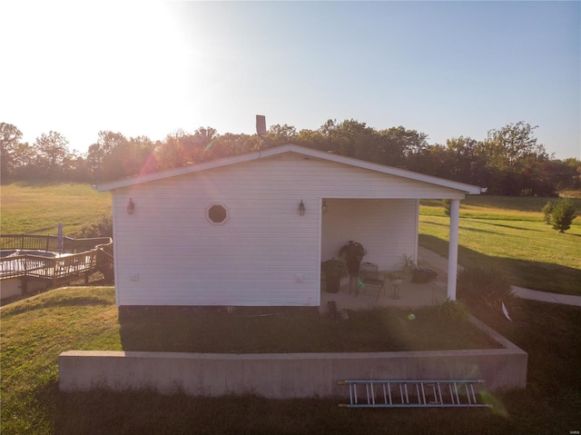 view of home's exterior featuring a yard and a patio