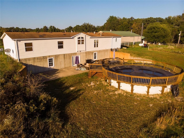 rear view of property featuring a yard and a patio area