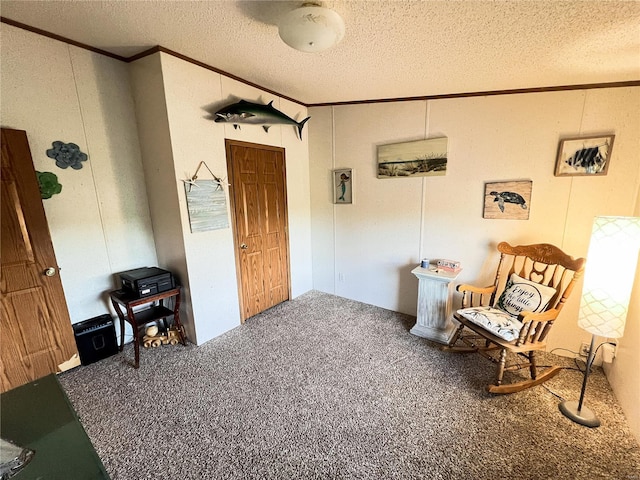 living area with a textured ceiling, crown molding, and carpet