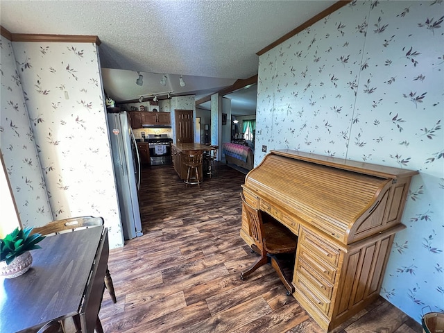 interior space with a textured ceiling, dark hardwood / wood-style floors, and vaulted ceiling