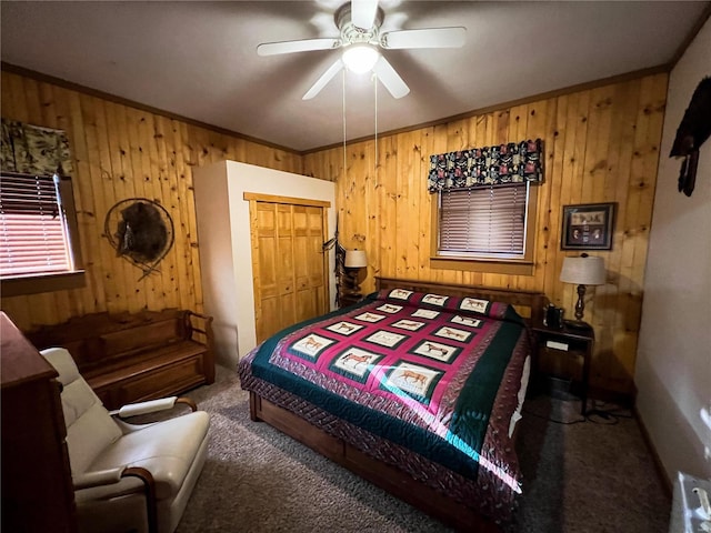 carpeted bedroom with ornamental molding, ceiling fan, wood walls, and a closet