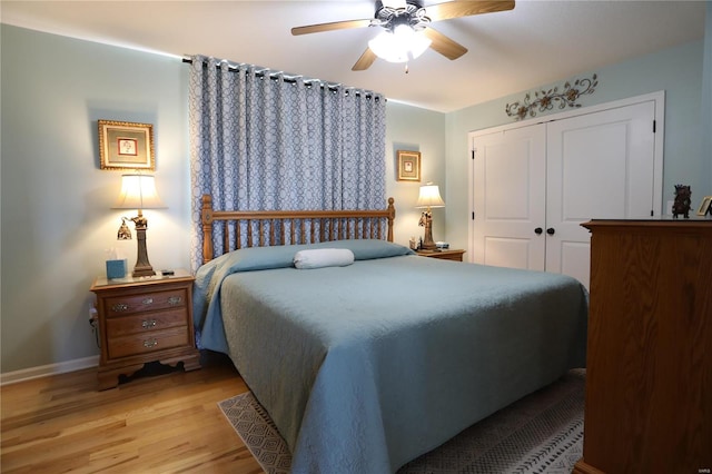 bedroom featuring ceiling fan, light wood-type flooring, and a closet