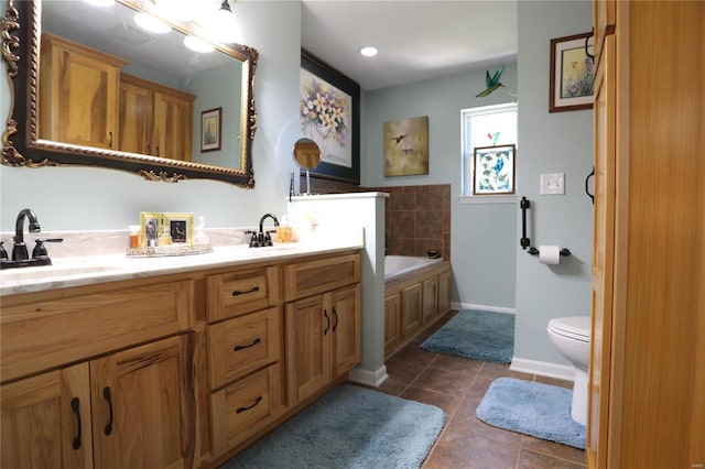 bathroom featuring vanity, toilet, a bath, and tile patterned floors