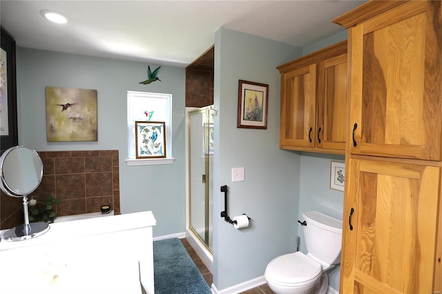 bathroom with a shower with shower door, toilet, and tile patterned floors