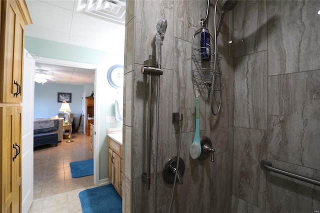 bathroom with ceiling fan, tile patterned floors, vanity, and walk in shower