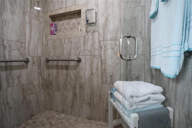 bathroom featuring a shower with shower door